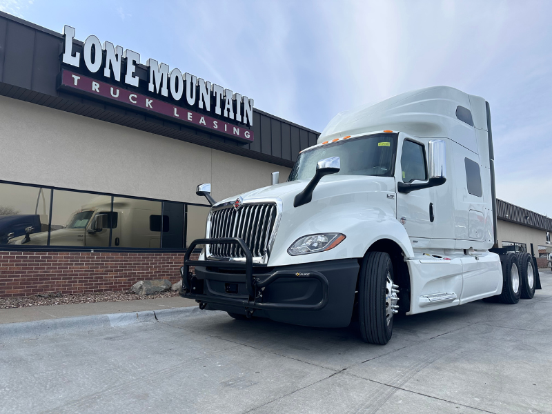 White 2022 International LT with Cummins X15 engine partked outside Lone Mountain Truck Leasing HQ in Carter Lake, Iowa