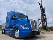 Blue 2027 Kenworth T680 in front of Lone Mountain sculpture