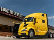 Yellow 2027 Volvo VNL 860 parked outside the Lone Mountain Truck Leasing headquarters in Carter Lake, Iowa