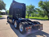 Rear and driver side of 2022 Black Peterbilt 579
