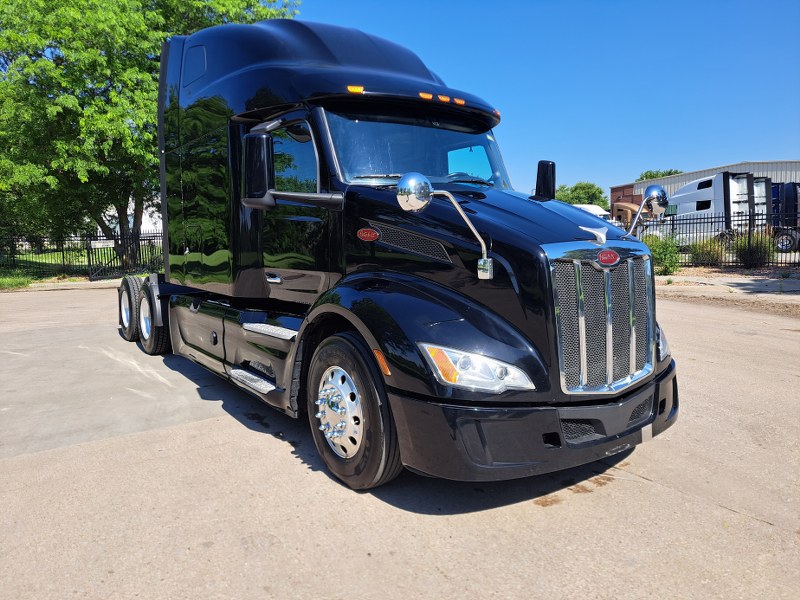 Passenger side and front of 2022 Black Peterbilt 579