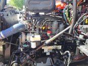 Engine and components under the hood of a 2022 Black Peterbilt 579