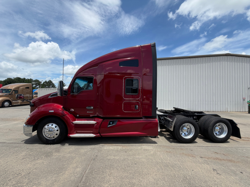 Driver's side of a maroon 2022 Kenworth T680