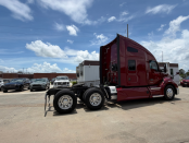 Rear and passenger's side of a maroon 2022 Kenworth T680