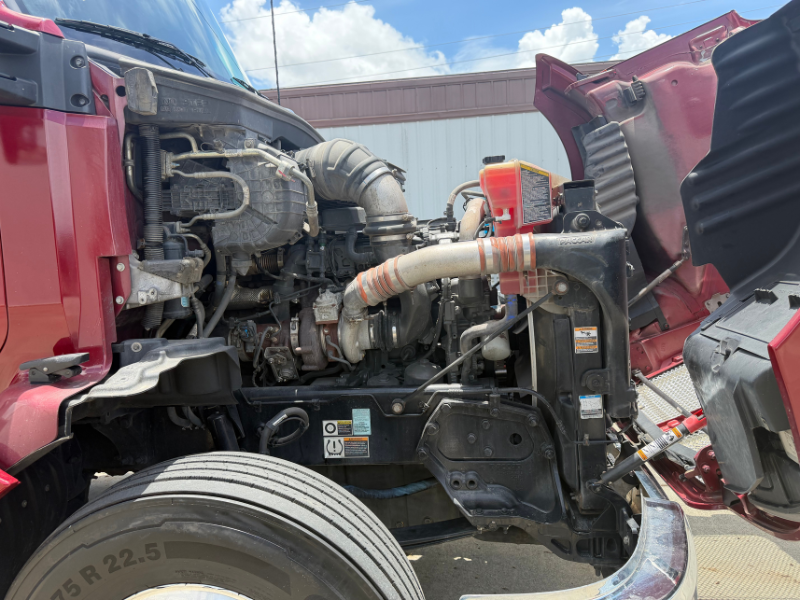 Hood of a maroon 2022 Kenworth T680 up with engine visible