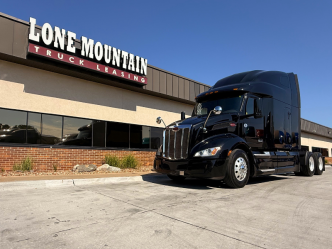 Black 2022 Peterbilt 579 parked outside the Lone Mountain Truck Leasing headquarters in Carter Lake, Iowa