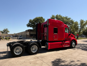 Passenger side of a red 2022 Peterbilt 579 mid-roof