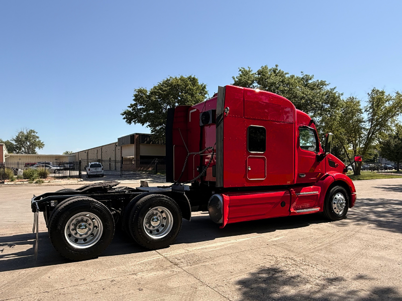 Passenger side of a red 2022 Peterbilt 579 mid-roof