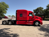 Passenger side of a red 2022 Peterbilt 579 midroof