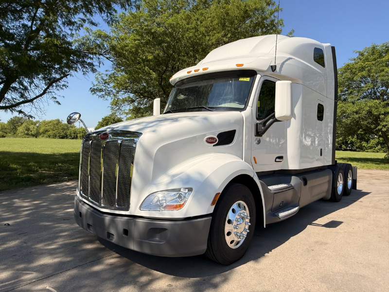Front and driver side of a white 2022 Peterbilt 579