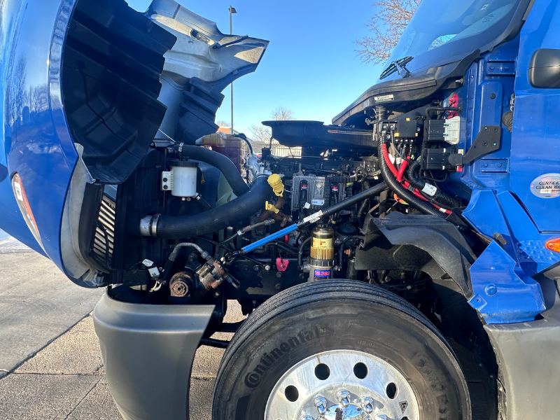 Hood up of a blue 2022 International LT with engine visible