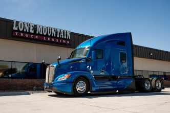 Blue 2027 Kenworth T680 Next Gen parked outside the Lone Mountain Truck Leasing headquarters in Carter Lake, Iowa