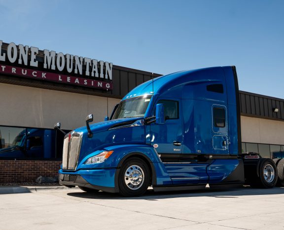 Blue 2027 Kenworth T680 Next Gen parked outside the Lone Mountain Truck Leasing headquarters in Carter Lake, Iowa