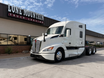 White 2027 Mid-Roof Kenworth T680 parked outside Lone Mountain Truck Leasing in Carter Lake, Iowa