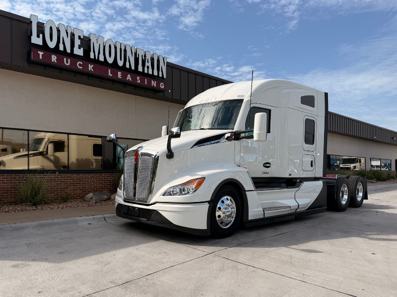 White 2027 Mid-Roof Kenworth T680 parked outside Lone Mountain Truck Leasing in Carter Lake, Iowa