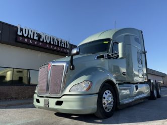 Used 2021 Kenworth T680 parked outside the Lone Mountain Truck Leasing headquarters in Carter Lake, Iowa