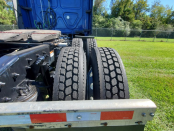 Rear tires of a blue 2022 Freightliner Cascadia