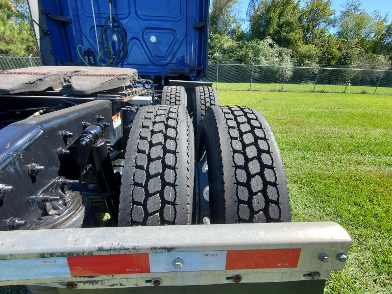 Rear tires of a blue 2022 Freightliner Cascadia