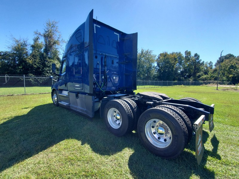 Driver's side and rear angle of a blue 2022 Freightliner Cascadia