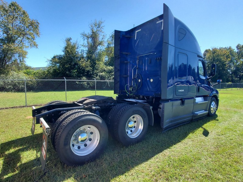 Passenger side rear of a blue 2022 Freightliner Cascadia