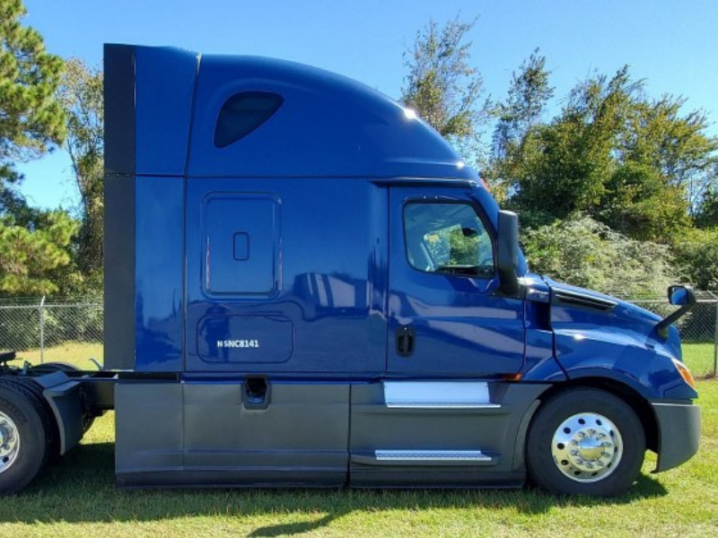 Passenger's side of a blue 2022 Freightliner Cascadia