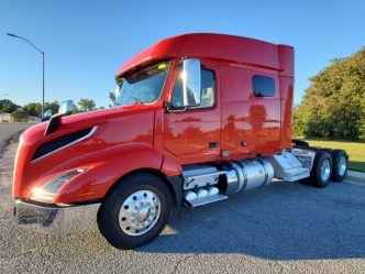 Mid-roof red 2023 Volvo VNL 740 driver's side and front exterior