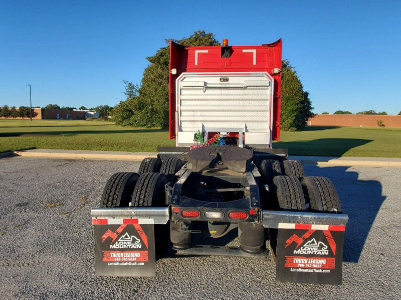 Rear view of exterior of a red 2023 Volvo VNL 740