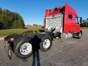 Rear and passenger's side view of a red 2023 Volvo VNL 740