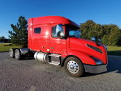 Front and passenger's side of the exterior of a red 2023 Volvo VNL 740